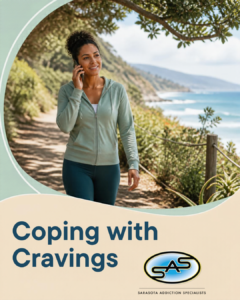 An adult on a shaded coastal walking path speaking with a trusted support person by phone